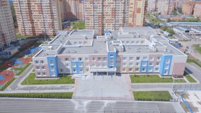 A complex of new sports facilities: a hockey field, a tennis court, a basketball court, running tracks and a football field in a new microdistrict. On football field are teenagers play football - Powered by Shutterstock - Get 15% off with code: PIKWIZARD15