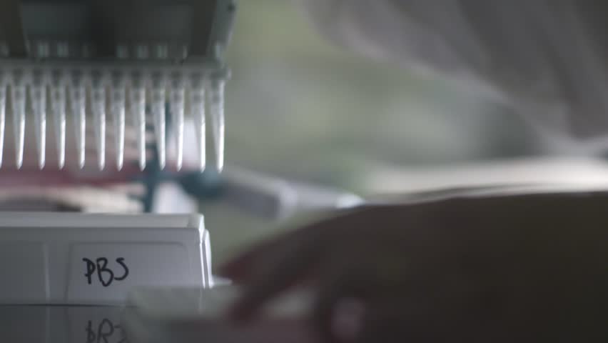 The process of using a pipette to transfer a PBS solution in a laboratory Royalty-Free Stock Footage #3396420239