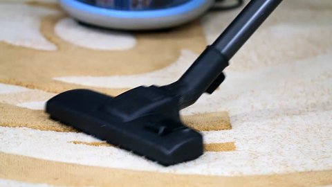 cleaning of dust from carpet with industrial vacuum cleaner