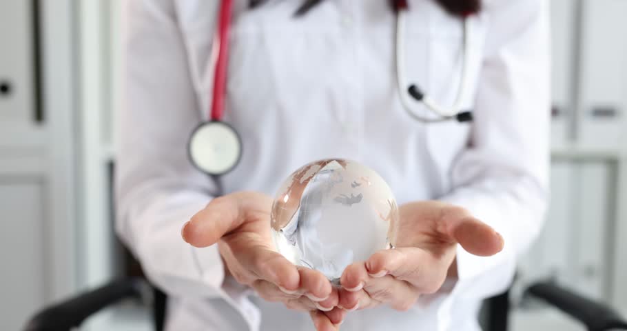 Doctor in white coat holds glass globe. World health organization concept Royalty-Free Stock Footage #3396517485
