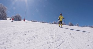 Front view pf professional skier skiing on slopes on a sunny winter day. Recorded at 120 fps on cinema camera. Ski run 04 clip 1 of 6.