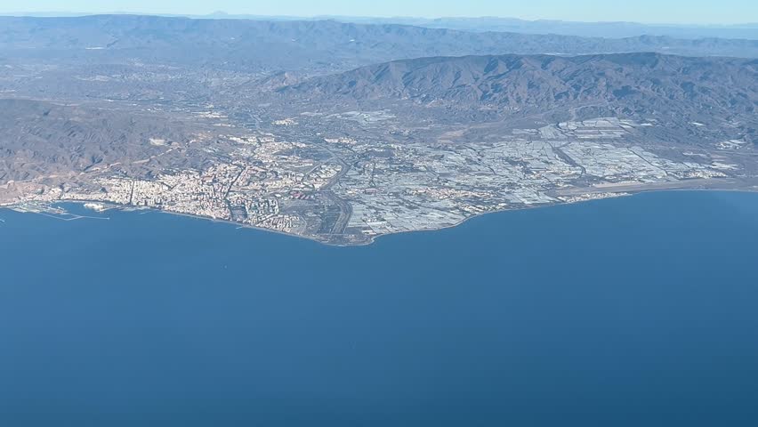 Almeria city, Spain, panoramic side view shot from a jet cockpit in a left turn at 3000m high in a bright and splendid morning. A pilot’s perspective.
