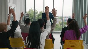 In a conference, business professionals raise their hands to ask questions, vote, or volunteer, reflecting audience engagement and effective teamwork in a corporate setting. - Powered by Shutterstock - Get 15% off with code: PIKWIZARD15