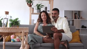 happy mature couple at home online shopping purchases with credit card - E-Commerce Concept - - Powered by Shutterstock - Get 15% off with code: PIKWIZARD15