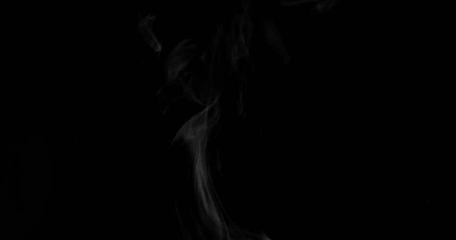 White steam from hot food or drink. White steam on a black background rises to the top. Cooking a hot meal in the kitchen.