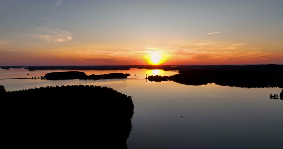 Aerial view of finnish lake vanaja and bridge during sunset in summer. Sunset reflections in the water. golden hour in finnish nature.