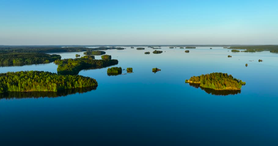 Aerial drone view of big lake with islands in Finland during summer. Open water of vanaja. Blue horizon of finnish lake vanajavesi