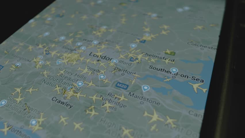 Online flight tracking on global map on smartphone screen. London, Great Britain. Cargo, shipping and Logistics concept