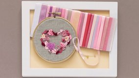 Making gift with your own hands. Embroidery as hobby. Video of hand embroidery with satin ribbons for Valentine's Day - delicate heart of pink and peach roses in hoop and set of satin ribbons in frame - Powered by Shutterstock - Get 15% off with code: PIKWIZARD15