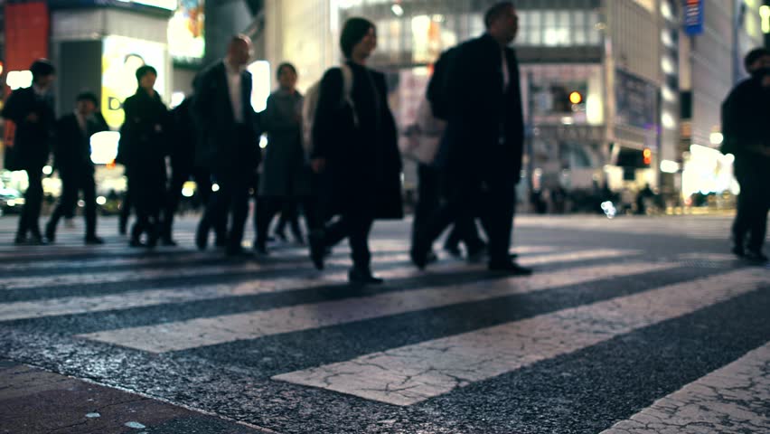 Crowd of busy unrecognisable people walking on a pedestrian crossing in Tokyo, Shibuya, Japan, pedestrian crossing at night, overcrowded urban lifestyle concept