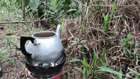 the process of boiling water while camping in the forest