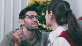 young couple shares spaghetti during romantic Christmas dinner	 - Powered by Shutterstock - Get 15% off with code: PIKWIZARD15