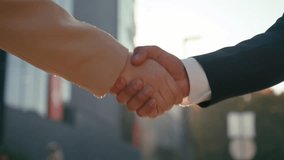 Close up business handshake together businessman businesswoman female male hands partnership meeting corporate cooperation success businesspeople collaboration colleagues handshaking in city sun light - Powered by Shutterstock - Get 15% off with code: PIKWIZARD15