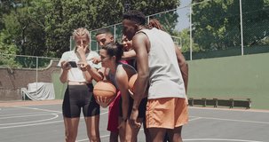 Basketball, phone and friends together at court, watch funny meme or video on social media. Smartphone, sports and group of happy people laughing at comedy, joke and fitness app outdoor in summer