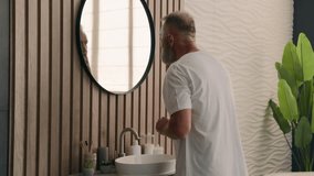 Retired old Caucasian man senior mature male grandpa walking come in bathroom looking at mirror reflection check fix grey hair hairdo gray haircut beard beauty routine procedure at morning preparing - Powered by Shutterstock - Get 15% off with code: PIKWIZARD15