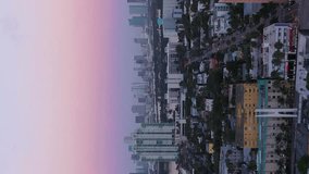 Urban Skyline of Miami Beach and Miami Downtown in Morning Twilight. Blue Hour. Aerial View. USA. Drone Flies Sideways. Medium Shot. Vertical Video