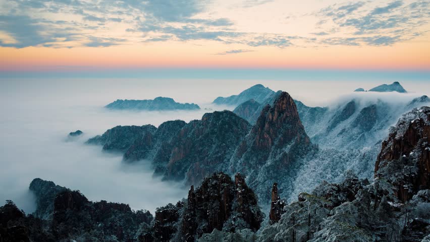 Time lapse looking out over a sea of fog at the Yellow Mountains (Huangshan) in China at sunset