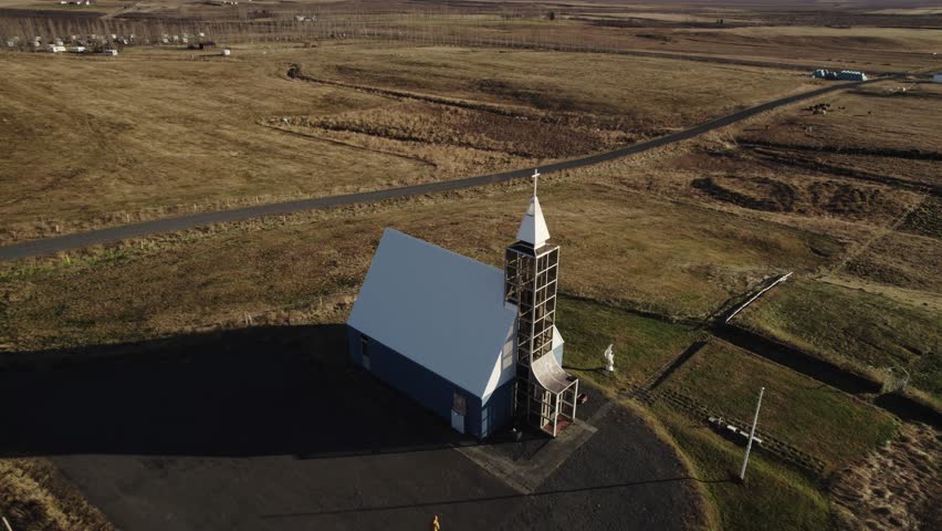 Lutheran Church Úthlíðarkirkja in Iceland, aerial backwards, countryside panorama