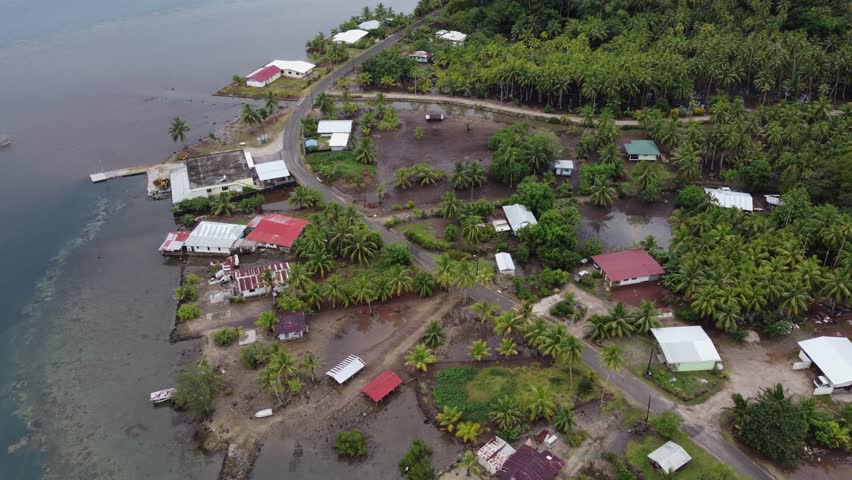 Aerial rotates over wet tropical coastline of Taha