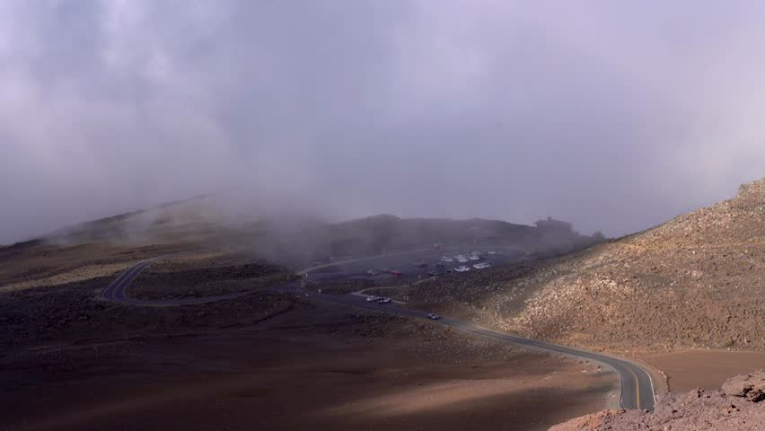 Haleakala National Park in Maui, Hawaii. Top tourist attraction, top of volcano at 10,000 ft elevation famous for Sunset sunrise over the clouds. Beautiful cloudy scenic overlook in hawaii