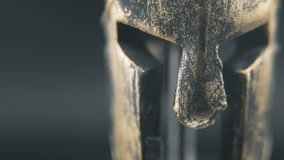 A close up macro detailed slow pan right shot of a spartan face design, warrior ancient greek bronze helmet, on a 360 rotating stand, studio lighting, 4K smooth movement - Powered by Shutterstock - Get 15% off with code: PIKWIZARD15