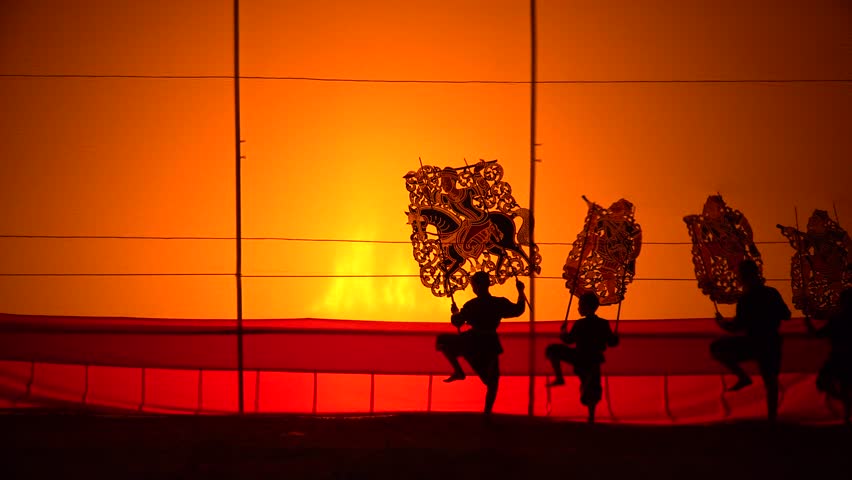 Grand Shadow Play "Nang Yai" , or shadow play, Traditional Thai dance Nang Talung or Nang Yai is dancing shadow play with fire lighting at night or in studio. Royalty-Free Stock Footage #33969097