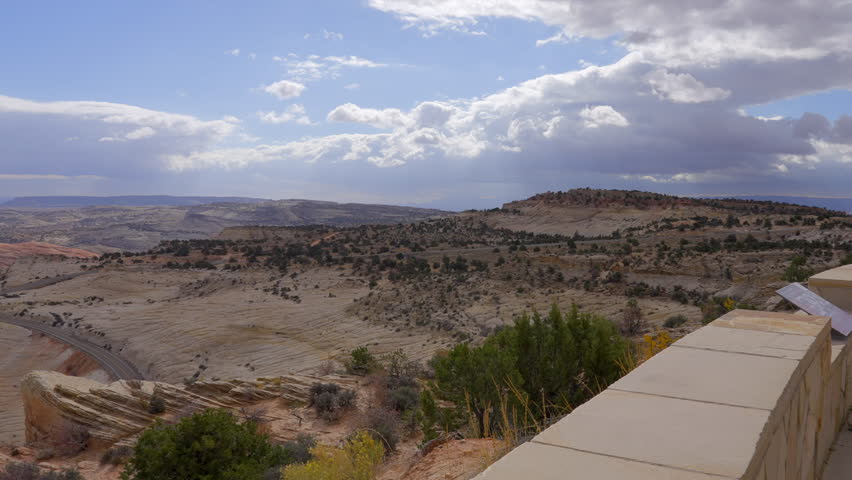 Establishing shot of brown mountains with green forest in Head of the Rock Overlook Scenic Root, Utah, North America. Day time on October. ProRes 422