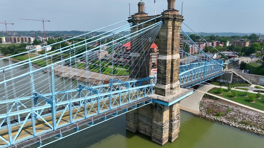 Bridge connecting Cincinnati, Ohio and Covington, Kentucky over Ohio River. Aerial rising shot of KY side.