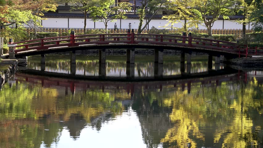 View Of Hasuike Bridge Over Reflective Pond At Koyasan. Slow Motion Shot