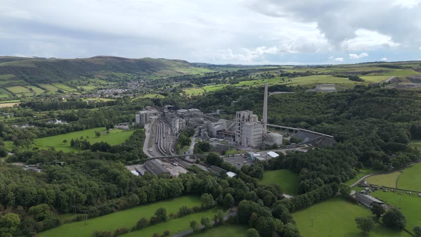 Wide aerial view across Breedon Hope cement works factory in idyllic rural Derbyshire Peak district