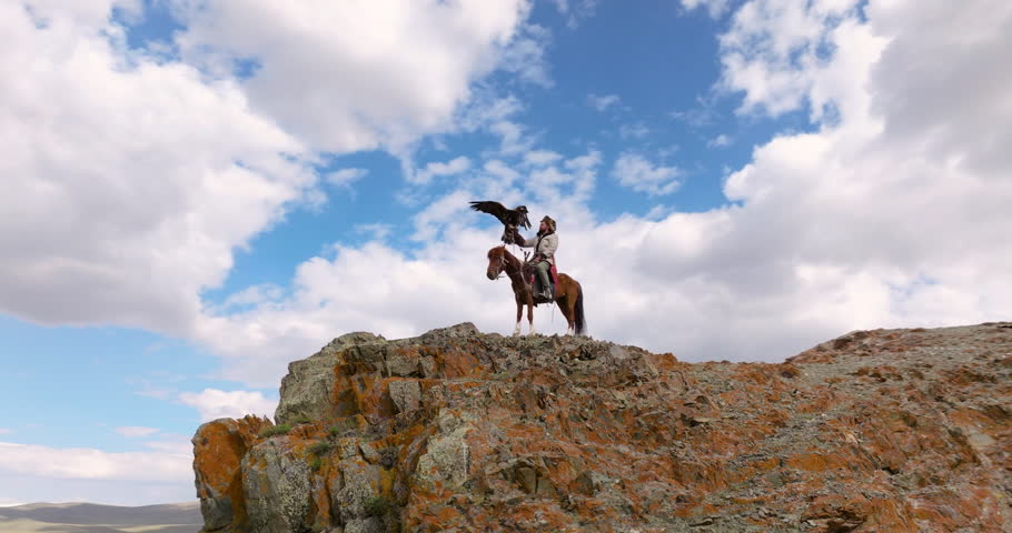 Eagle Hunter On Horse Preparing The Eagle To Fly In Western Mongolia. - aerial orbit shot