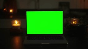 Elevate Your Project with Magical Video Clips in a Dark Room: Green Screen Laptop and Candlelight