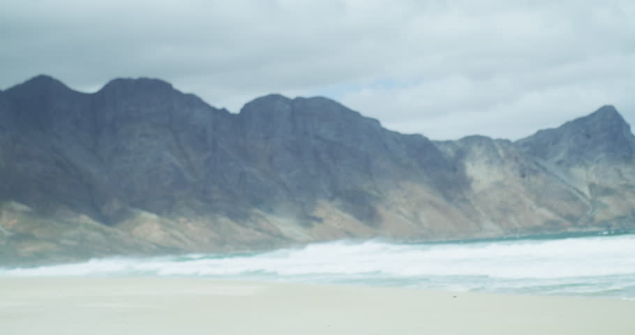 Man, beach and walking to waves with surfboard for water sports, summer travel and tropical holiday in Cape Town. Surfer at sea, ocean and sunshine for surfing adventure, hobby and vacation in nature
