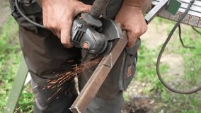 Worker cutting metal tube using an Angle Grinder. Bright sparks and flashes - Powered by Shutterstock - Get 15% off with code: PIKWIZARD15