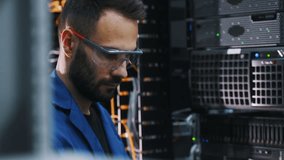 Young man is working with internet equipment and wires in server room. - Powered by Shutterstock - Get 15% off with code: PIKWIZARD15