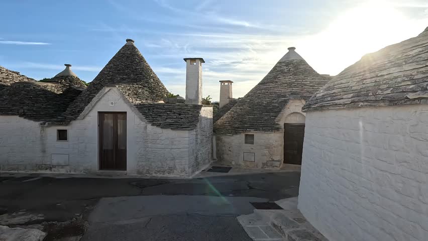 Charm of Trulli Houses: As you wander through the cobblestone streets of Alberobello, you'll find yourself surrounded by the enchanting trulli houses Royalty-Free Stock Footage #3397239631