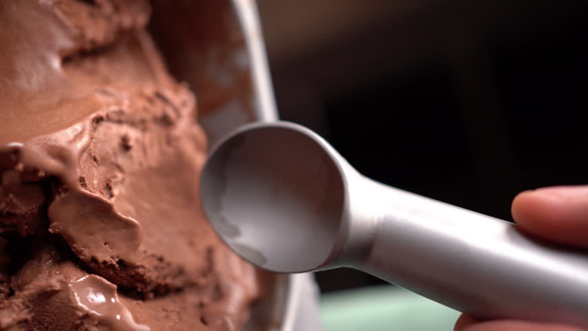 scoop chocolate ice cream with a special spoon and form a ball. Close-up Royalty-Free Stock Footage #3397288909