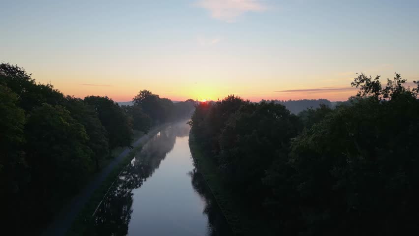 Beautiful sunset over a river with green bushes and color rich sky. High quality photo