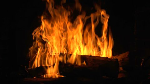 Slow Motion, Bright flames leap from logs burning in fireplace. 1080p