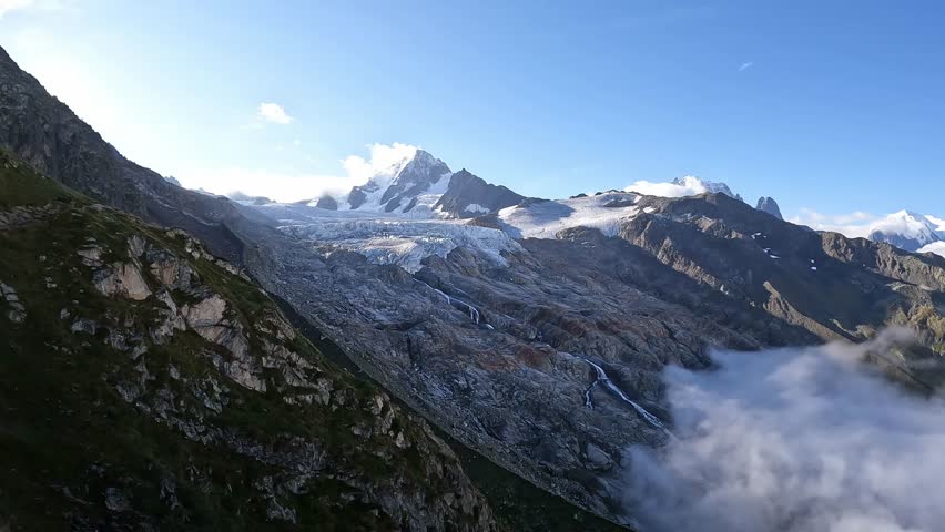 Glacier du Tour - glacier of France, rocky landscape. Mountains, view of Mont Blanc, French Alps, Europe, beautiful landscape. Tourism. The landscape is above the clouds