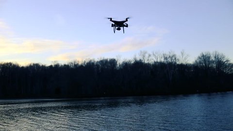 Derwood, MD - December 14, 2017: A DJI Phantom 4 Pro Obsidian drone hovers in the air at Lake Needwood in Rock Creek Park, Maryland.