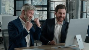 Two surprised happy Caucasian businessmen men business partner employees colleagues looking computer screen celebrating victory win patent rejoicing at achievement successful deal high sales growth - Powered by Shutterstock - Get 15% off with code: PIKWIZARD15