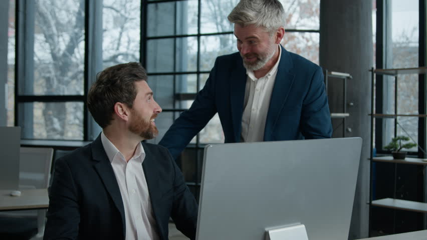 Two successful excited Caucasian businessmen workers looking computer screen in office men business partners investors coworkers celebrating successful giving high five rejoice achieving good result Royalty-Free Stock Footage #3397492681