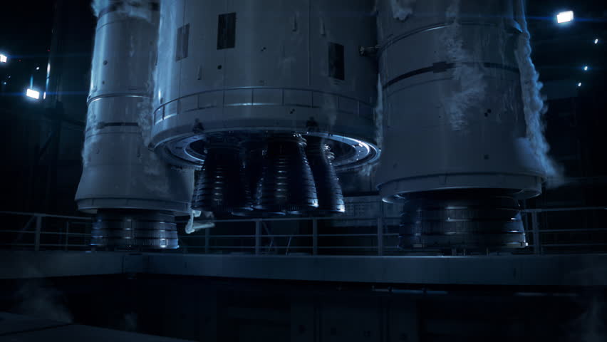 Vertical Takeoff of Large Rocket with Boosters. Space Exploration Rocket Launch at Night. Close-up shot of Rocket Engine Ignition. Powerful and Hot Flames Burst out of the Nozzle after Initial Impulse
