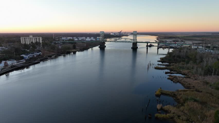 Sunrise over Cape Fear River with the Cape Fear Memorial Bridge in the background and downtown Wilmington, North Carolina to the left.