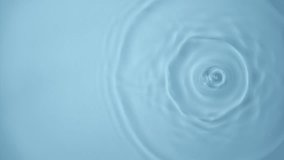 Natural water splashing. Rings and ripple top view. Clear drop of cosmetic essence serum falling in slow motion from above. Body moisturizing cosmetics. Beauty luxury product blue liquid background - Powered by Shutterstock - Get 15% off with code: PIKWIZARD15