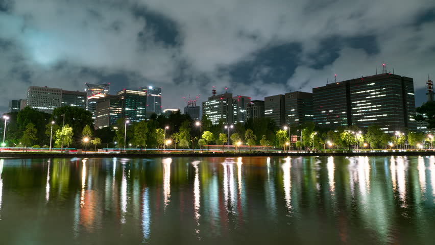 Timelapse of government buildings over moat at Imperial Palace in Tokyo, Japan