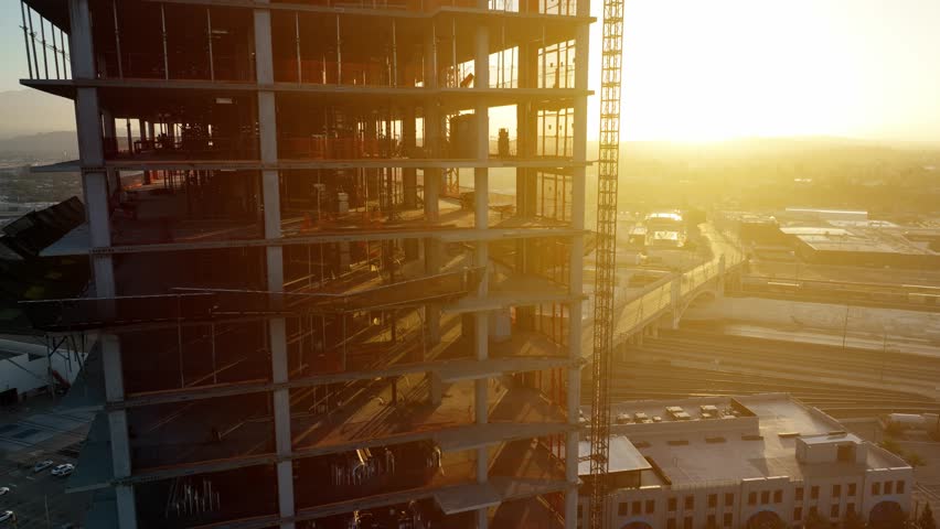 Aerial shot of a new high-rise building under construction at sunrise Royalty-Free Stock Footage #3397596463