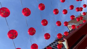 Vertical video. Chinese red lanterns in the blue sky, symbolizing wealth and happiness. Lunar New Year celebration.