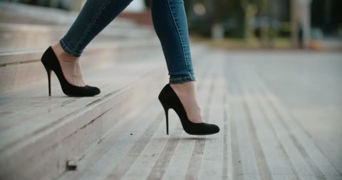close-up of female legs in high heels walking on the stairs